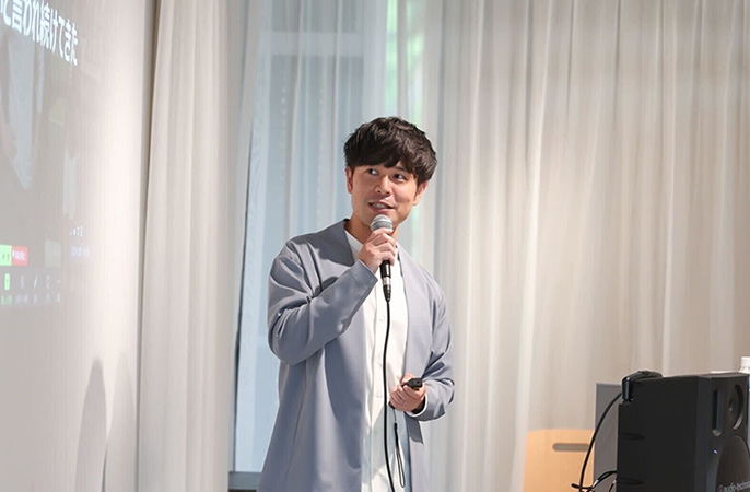 マイクを持ち話す飯野さん