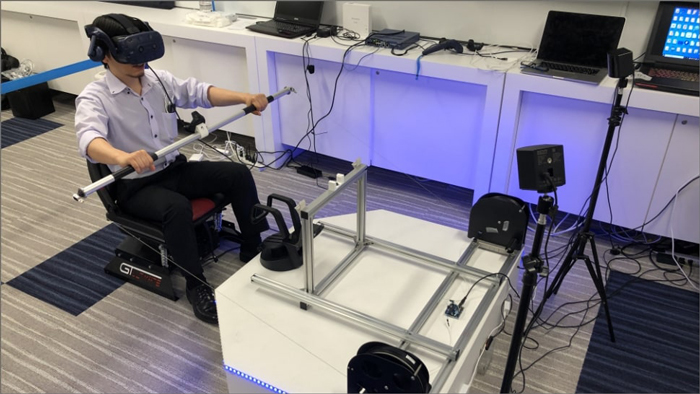 Photo: The user operates a master system paddle which moves the kayak's robot thrusters causing it to move across the surface of the water