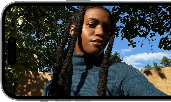 A horizontal view of an iPhone 14 Pro displaying a sharp and vibrant selfie.